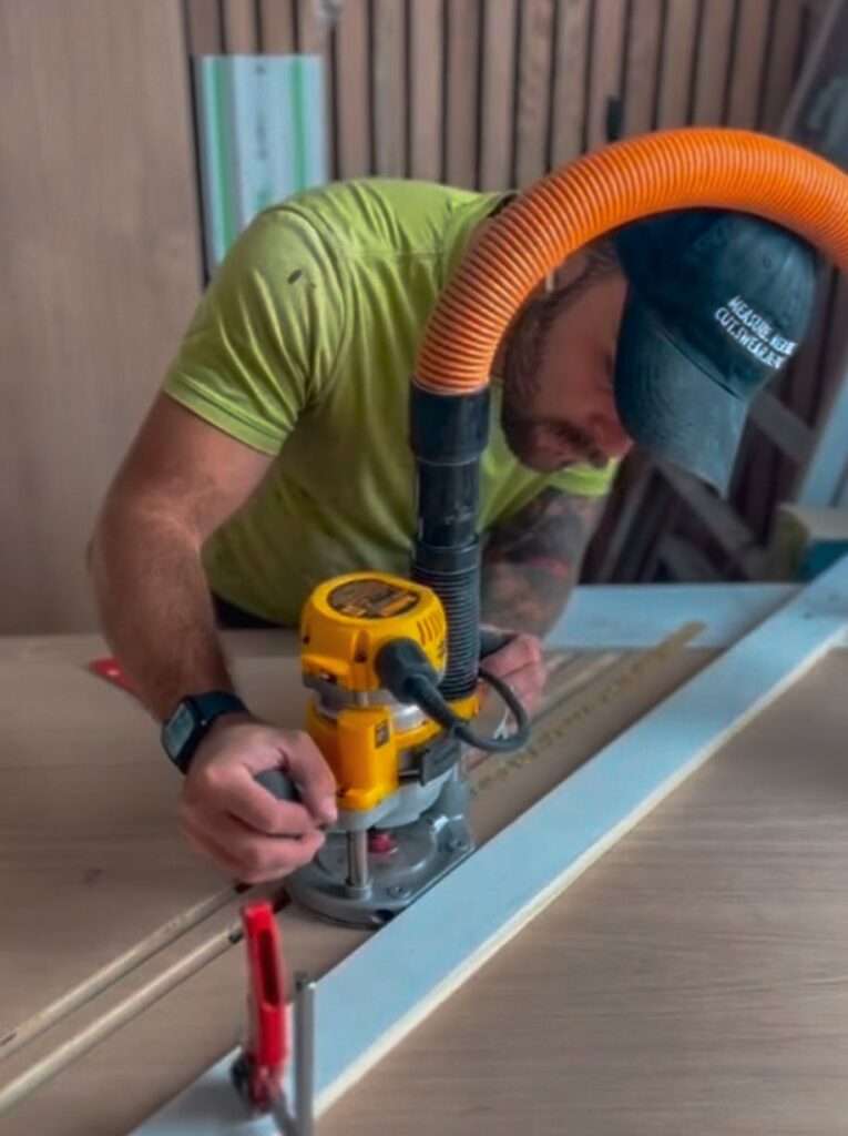 Coimbra Carpentry craftsman working with a router on custom millwork